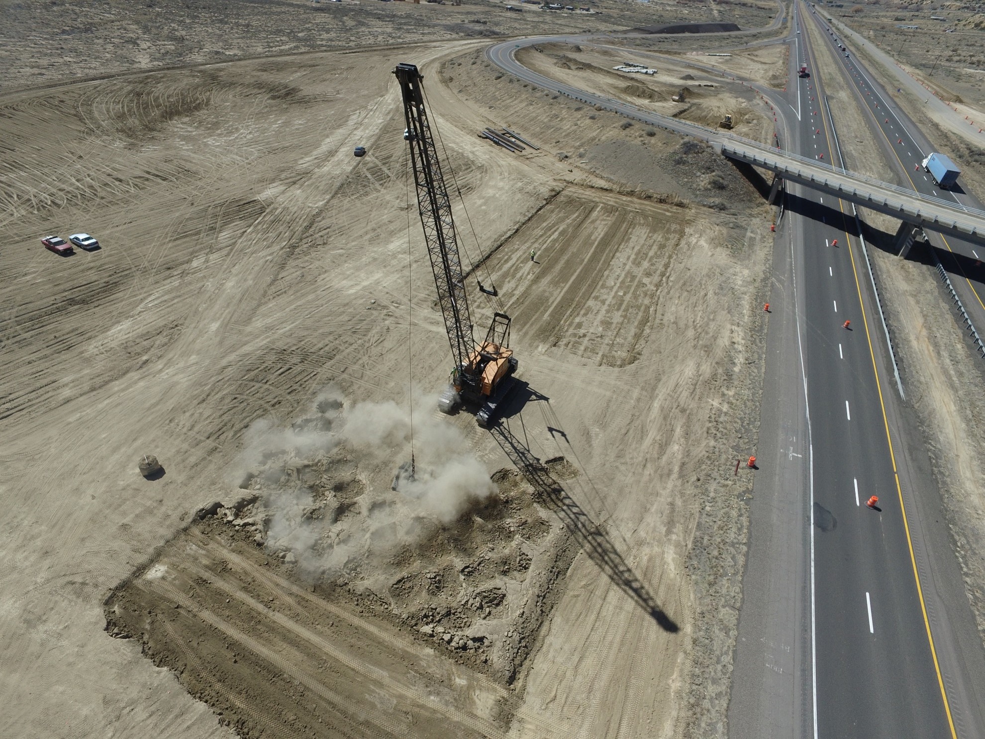Dynamic compaction at work adjacent to I-40 in Cibola County, New Mexico.  (Courtesy of Densification, Inc.)