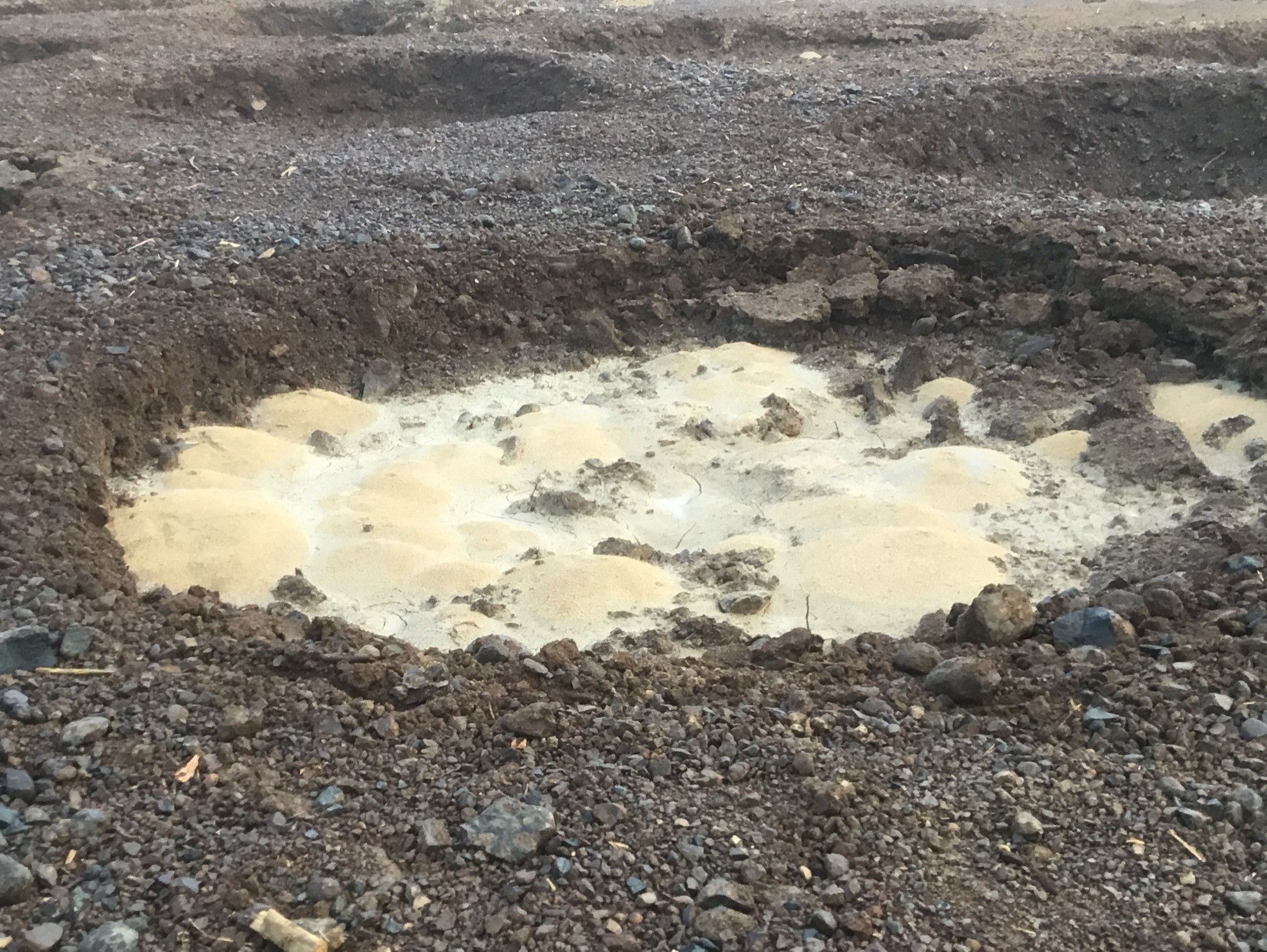Sand boils within a crater following high-energy compaction work.   (Courtesy of Chris Woods)