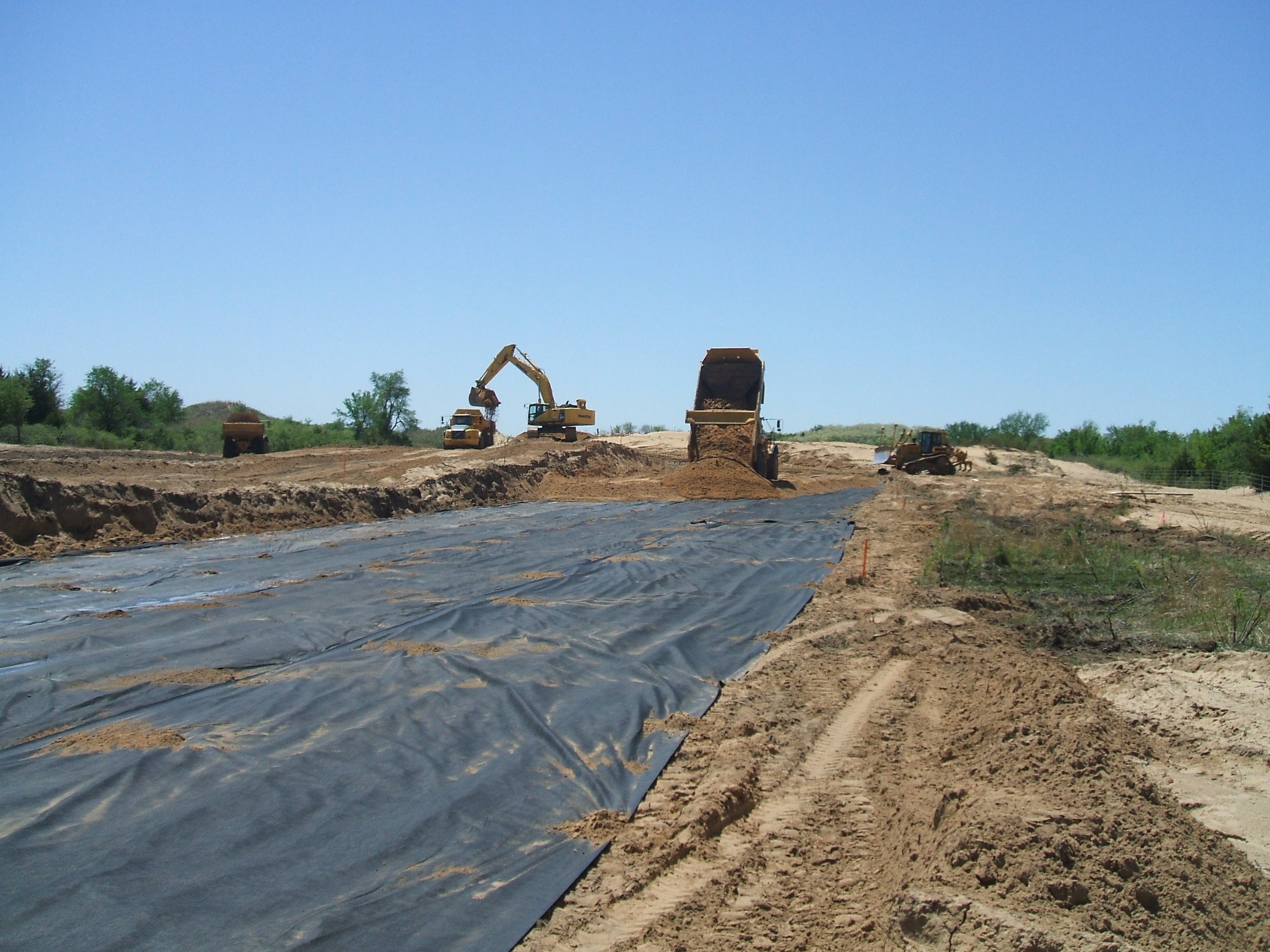 Placement of geosynthetic in roadway showing backfilling operations. Courtesy Kansas Department of Transportation. Placement of geosynthetic in roadway showing backfilling operations. Courtesy Kansas Department of Transportation.
