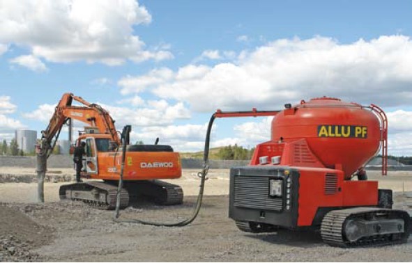 The ALLU mass stabilization system with excavator-mounted mixing arm and binder delivery shuttle. From ALLU (2007). The ALLU mass stabilization system with excavator-mounted mixing arm and binder delivery shuttle. From ALLU (2007).