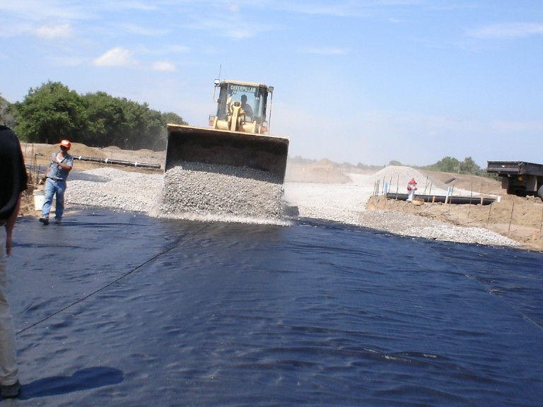 Placement of base material on top of the geotextile. Courtesy of TenCate Geosynthetics North America. Placement of base material on top of the geotextile. Courtesy of TenCate Geosynthetics North America.
