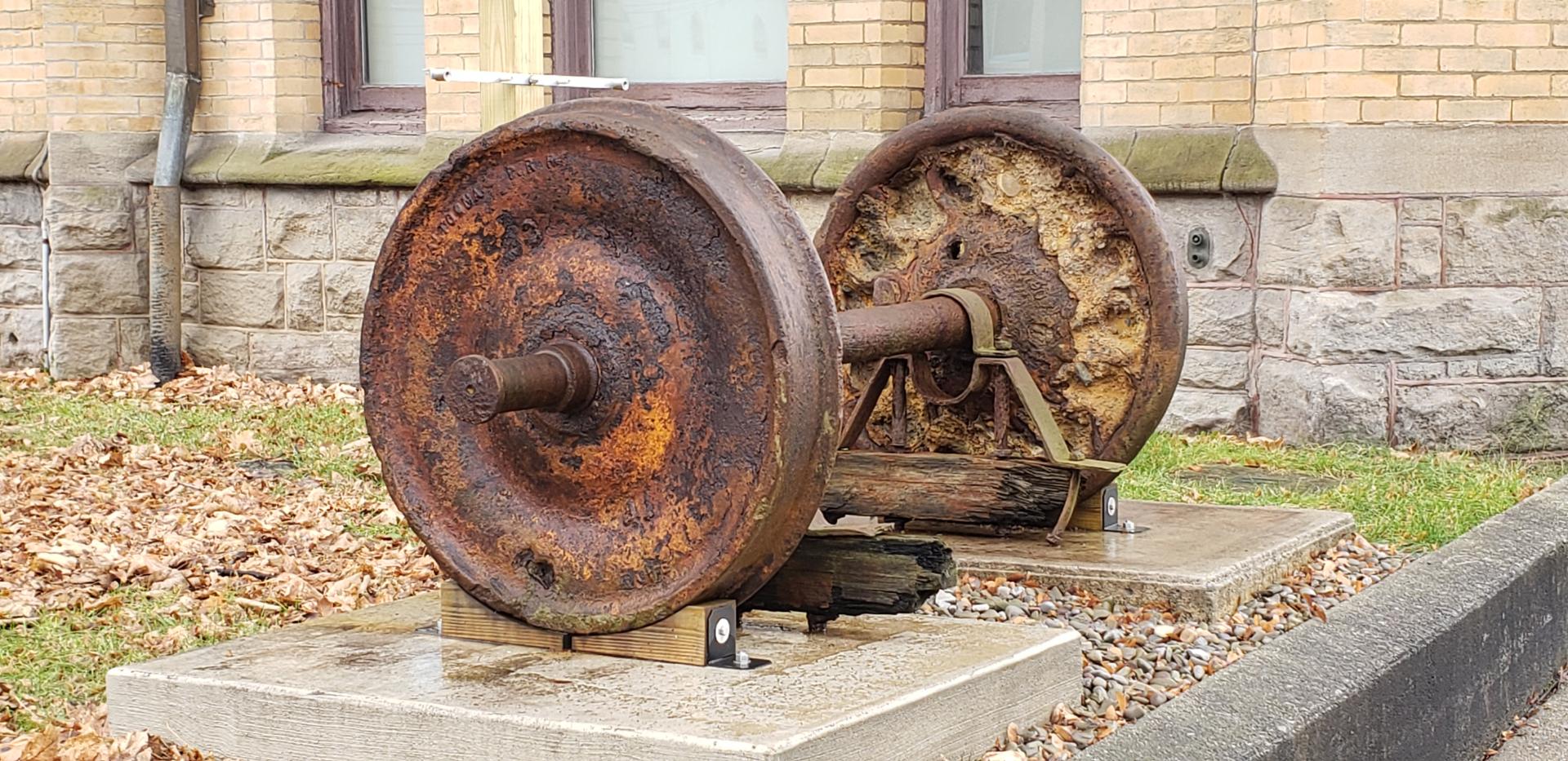 Photo of rust-covered railroad car axle.