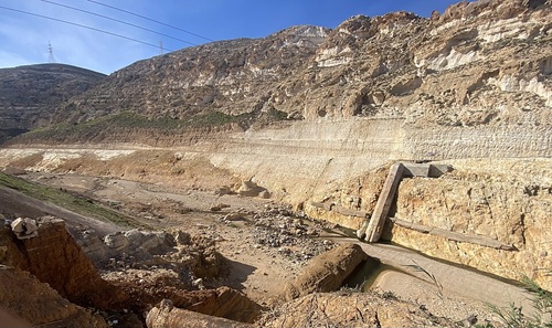 Color photo of the remnants of the Al-Bilad Dam after its breach