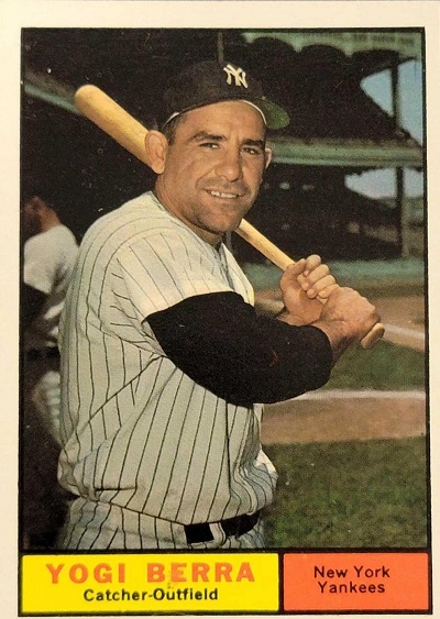 Baseball Card for Yogi Berra. Berra poses holding a bat over his left shoulder. The card is captioned Yogi Berra, Catcher-Outfield, New York Yankees
