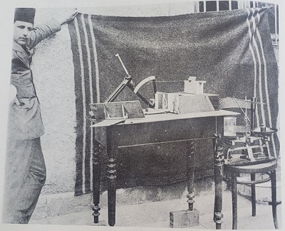 Black and white photo of Karl Terzaghi and a table covered with testing apparatus