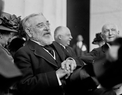 Black and white photograph of Robert Todd Lincoln. He is an elderly man with white hair and beard, wearing small wire spectacles and a formal morning dress suit.