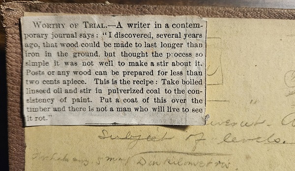 Photograph of newspaper clipping attched to antique book